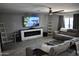 Spacious living room with modern fireplace, ceiling fan, plank floors and recliner couches at 4755 E Gary St, Mesa, AZ 85205