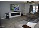Comfortable living room featuring a large sectional sofa, modern fireplace, and a mounted television at 4755 E Gary St, Mesa, AZ 85205