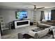 Comfortable living room features a large sectional, modern fireplace, and a mounted television at 4755 E Gary St, Mesa, AZ 85205
