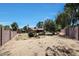 Large, sandy backyard with a fenced pool and mature trees, ready for landscaping and outdoor enjoyment at 4854 E Blanche Dr, Scottsdale, AZ 85254