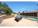 Backyard retreat featuring a tiled pool, fire pit, and low-maintenance landscaping for ultimate relaxation at 4854 E Blanche Dr, Scottsdale, AZ 85254