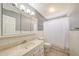 Bright bathroom featuring a single marble vanity, tiled floors and walls, and a shower-tub combo at 4854 E Blanche Dr, Scottsdale, AZ 85254