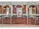 Double vanity bathroom with tile floor, granite counters, dark cabinetry and a large mirror at 4854 E Blanche Dr, Scottsdale, AZ 85254