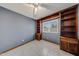 Comfortable bedroom with neutral paint, tiled flooring, built-in bookshelves, and great natural light at 4854 E Blanche Dr, Scottsdale, AZ 85254