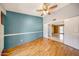 Bedroom featuring hardwood floors, blue accent wall, and connected with a separate seating area at 4854 E Blanche Dr, Scottsdale, AZ 85254