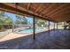 View from covered patio to the fenced pool and backyard, great for enjoying the outdoors year-round at 4854 E Blanche Dr, Scottsdale, AZ 85254