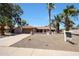 Expansive single-Gathering home with desert landscaping, complemented by mature palm trees and a spacious front yard at 4854 E Blanche Dr, Scottsdale, AZ 85254