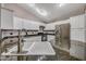 Granite countertops, stainless appliances, and white cabinets adorn the kitchen at 4854 E Blanche Dr, Scottsdale, AZ 85254