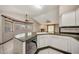 Kitchen showcases a breakfast bar, dishwasher, white cabinets, and granite counters at 4854 E Blanche Dr, Scottsdale, AZ 85254