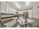 This kitchen includes granite counters, stainless appliances, and white cabinets at 4854 E Blanche Dr, Scottsdale, AZ 85254