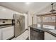 Bright kitchen offers stainless steel refrigerator, granite counters, and tiled floors at 4854 E Blanche Dr, Scottsdale, AZ 85254