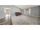 Spacious living room with plush carpeting and an adjoining room with wood flooring, offering flexible living space at 4854 E Blanche Dr, Scottsdale, AZ 85254