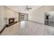 Bright living room features tile flooring, fireplace, ceiling fan, and access to backyard at 4854 E Blanche Dr, Scottsdale, AZ 85254