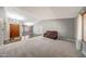 Open-concept living room with a mix of plush carpeting, wood floors, and comfortable seating with plenty of natural light at 4854 E Blanche Dr, Scottsdale, AZ 85254