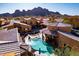 Stunning aerial view of backyard pool, community homes and mountain views in a desert setting at 5370 S Desert Dawn Dr # 56, Gold Canyon, AZ 85118