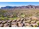 Expansive aerial view showcases the property, surrounding landscape, and stunning mountain backdrop at 5370 S Desert Dawn Dr # 56, Gold Canyon, AZ 85118