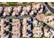 Aerial shot showcasing a desert townhouse community with a central water feature, pool, and beautifully landscaped surroundings at 5370 S Desert Dawn Dr # 56, Gold Canyon, AZ 85118