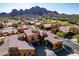 Beautiful aerial view of desert townhouses with terracotta tile roofs in a well-maintained community with mountain views at 5370 S Desert Dawn Dr # 56, Gold Canyon, AZ 85118