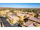 An aerial view of desert townhouses with terracotta tile roofs showcasing views of mountains, desert, and swimming pool at 5370 S Desert Dawn Dr # 56, Gold Canyon, AZ 85118