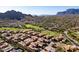 Stunning aerial view of a desert community with golf course, mountains, and well-maintained homes with terracotta roofs at 5370 S Desert Dawn Dr # 56, Gold Canyon, AZ 85118