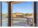 Scenic balcony view of a community pool and surrounding buildings under a clear sky at 5370 S Desert Dawn Dr # 56, Gold Canyon, AZ 85118