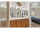 Bathroom featuring double sinks with wooden cabinets and a walk-in shower, designed for functionality and ease at 5370 S Desert Dawn Dr # 56, Gold Canyon, AZ 85118