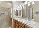 Well-lit bathroom with double sinks, a large mirror, and a walk-in shower offering both style and practicality at 5370 S Desert Dawn Dr # 56, Gold Canyon, AZ 85118
