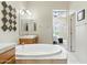 Bright bathroom featuring a soaking tub, dual vanities, and a decorative accent wall at 5370 S Desert Dawn Dr # 56, Gold Canyon, AZ 85118
