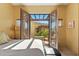 Bedroom with outdoor access to the sunlit balcony area with furniture for relaxation and beautiful views at 5370 S Desert Dawn Dr # 56, Gold Canyon, AZ 85118