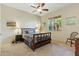 Cozy bedroom featuring a ceiling fan, natural light from two windows, and neutral tones for a calming atmosphere at 5370 S Desert Dawn Dr # 56, Gold Canyon, AZ 85118