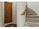 Inviting entryway with a solid wood door and staircase, offering a warm welcome and access to upper levels at 5370 S Desert Dawn Dr # 56, Gold Canyon, AZ 85118
