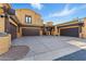 Property featuring a three-car garage, inviting entrance, and desert-style landscaping at 5370 S Desert Dawn Dr # 56, Gold Canyon, AZ 85118