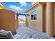 Side yard view with a private patio, desert landscaping and entry gate at 5370 S Desert Dawn Dr # 56, Gold Canyon, AZ 85118