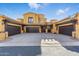 Desert home featuring a symmetrical facade, three-car garage, and tasteful landscaping at 5370 S Desert Dawn Dr # 56, Gold Canyon, AZ 85118