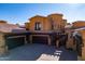 Exterior view of a home showcasing the tile roof, and multi-car garages at 5370 S Desert Dawn Dr # 56, Gold Canyon, AZ 85118