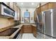 Well-lit kitchen with stainless steel appliances, granite countertops, and wood cabinetry offering modern convenience and style at 5370 S Desert Dawn Dr # 56, Gold Canyon, AZ 85118