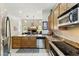 Open kitchen with granite countertops, stainless steel appliances, and adjacent living space at 5370 S Desert Dawn Dr # 56, Gold Canyon, AZ 85118