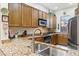Beautiful kitchen with granite countertops, custom wood cabinets, and stainless steel appliances at 5370 S Desert Dawn Dr # 56, Gold Canyon, AZ 85118
