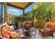 Outdoor patio area with comfortable seating, lush greenery, and a grill, perfect for relaxation and outdoor dining at 5370 S Desert Dawn Dr # 56, Gold Canyon, AZ 85118