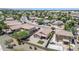 An aerial view of a well-maintained community with desert landscaping, block wall fences and houses with tile roofs at 597 S 167Th Dr, Goodyear, AZ 85338
