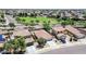 An aerial view shows a neighborhood with houses, green spaces, and roads on a sunny day at 597 S 167Th Dr, Goodyear, AZ 85338