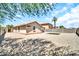 View of the home's backyard with gravel and small patch of green, enclosed by a block wall fence at 597 S 167Th Dr, Goodyear, AZ 85338