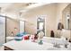 Bright bathroom featuring a large mirror, wood cabinets and a sink at 597 S 167Th Dr, Goodyear, AZ 85338