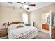 Cozy bedroom featuring a bed with a white blanket and a ceiling fan at 597 S 167Th Dr, Goodyear, AZ 85338