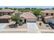 Aerial view of a single-Gathering home featuring a tile roof, desert landscaping, and a two-car garage at 597 S 167Th Dr, Goodyear, AZ 85338