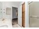 Well-lit bathroom view includes a door leading to a bedroom, a shower, and built in storage at 6730 E Hermosa Vista Dr # 72, Mesa, AZ 85215