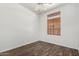 Bedroom features wood-look flooring, a ceiling fan, and a window with horizontal blinds at 6730 E Hermosa Vista Dr # 72, Mesa, AZ 85215