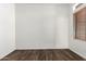 A view of wood look flooring, window with horizontal blinds, and base trim at 6730 E Hermosa Vista Dr # 72, Mesa, AZ 85215