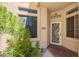 View of a front door with a decorative screen and a manicured garden on the side at 6730 E Hermosa Vista Dr # 72, Mesa, AZ 85215