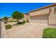 Row of beige houses with front-facing garages framed by desert landscaping under a clear blue sky at 6730 E Hermosa Vista Dr # 72, Mesa, AZ 85215